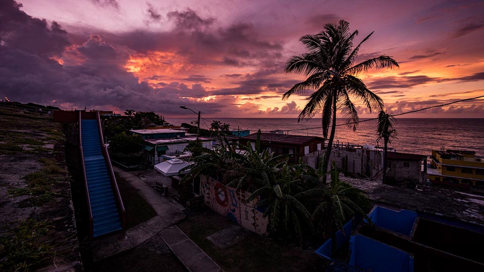 The sun setting over the neighborhood Barrio La Perla in Puerto Rico.