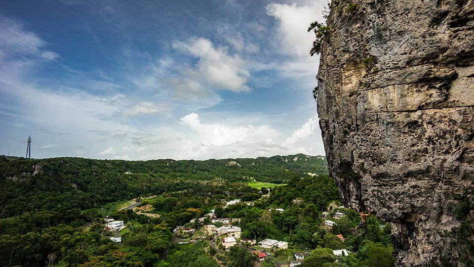 The epic climb My Right Foot 5.11c/6c+ in Caliche near Ciales, PR. If you look closely on the bottom right, you can see Will dangling from the rocks!