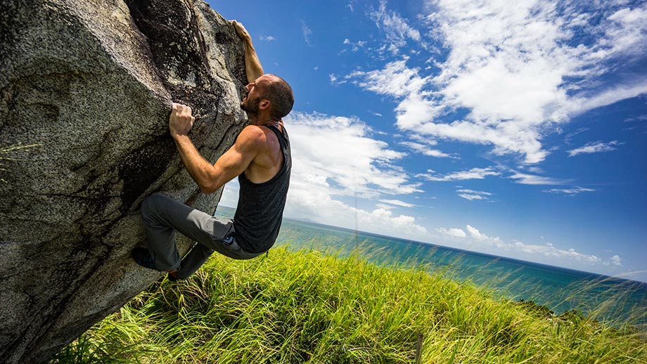 Will climbing a boulder near Yabucoa. That grass there might look beautiful, but it was an itch fest to walk through without a machete!