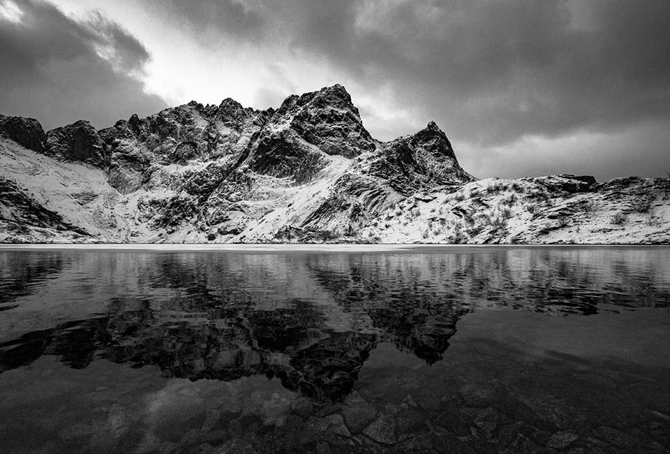 Reflections on Svartvatnet, a small mountain lake.